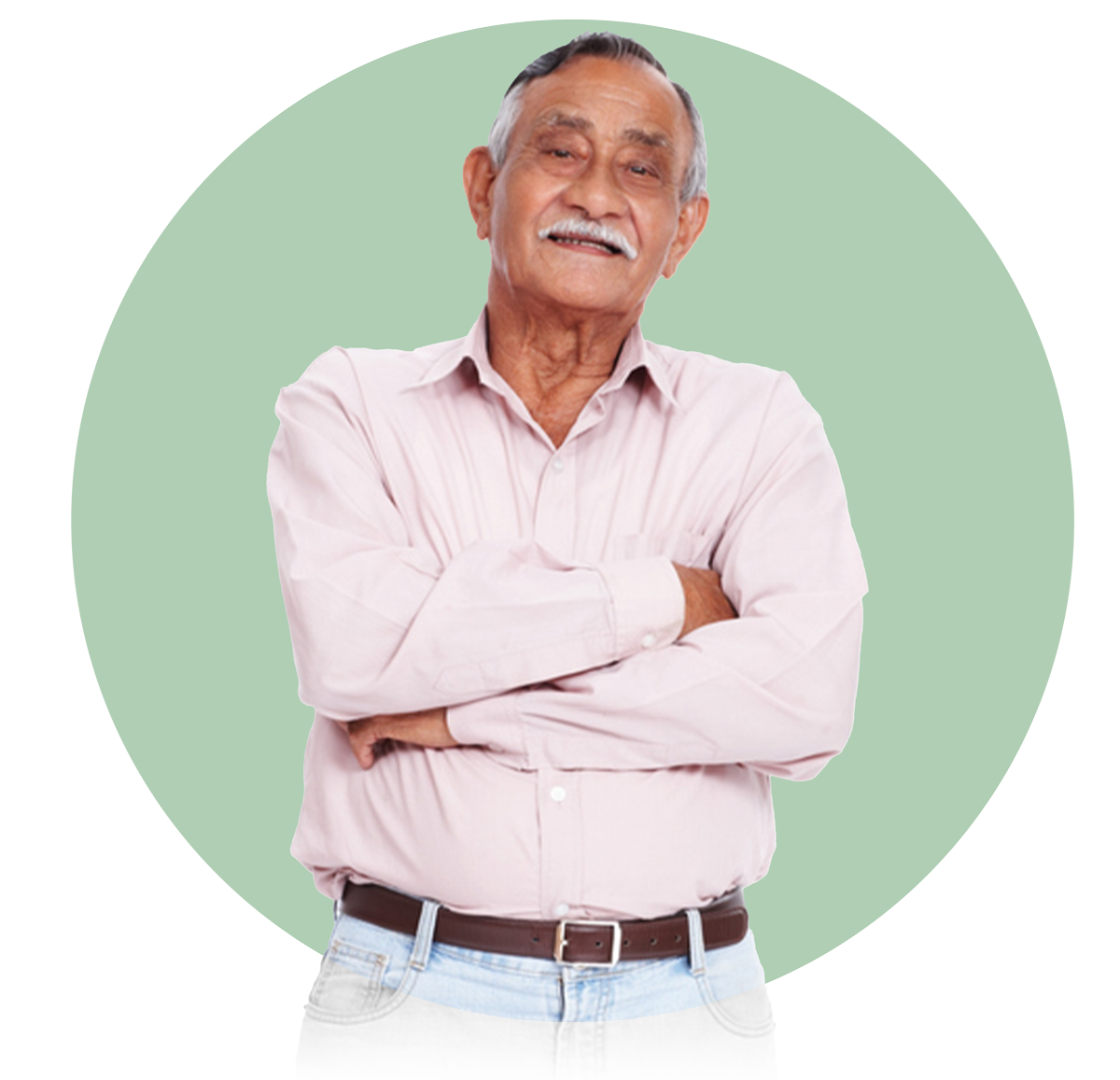 Senior man smiling with arms crossed wearing a light pink shirt and belt against a pale green background.